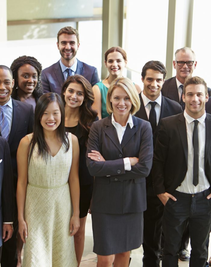 Portrait Of Multi-Cultural Office Staff Standing In Lobby