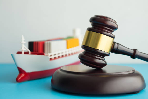 Container cargo ship with hammer judge gavel background. International trad law concept. International trade law includes framework rules, regulations and customs governing trade between nations